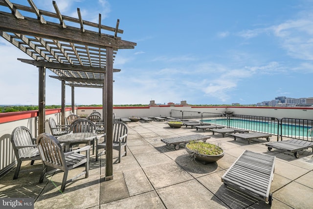 view of patio with a pergola and a community pool