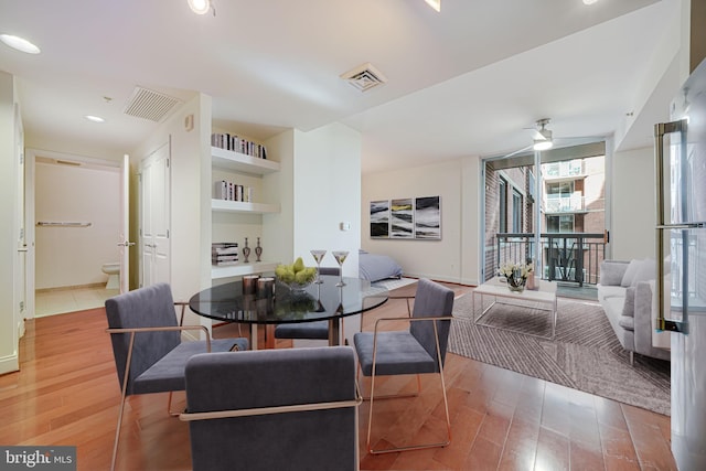 dining room with visible vents, ceiling fan, and light wood-style flooring