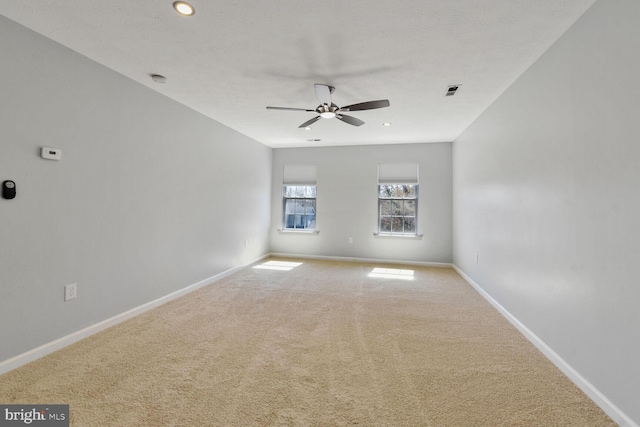 empty room featuring carpet floors, baseboards, a ceiling fan, and recessed lighting