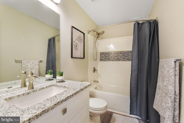bathroom featuring vanity, shower / bath combination with curtain, and toilet