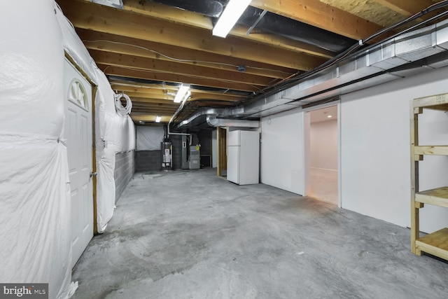 unfinished below grade area with freestanding refrigerator and water heater