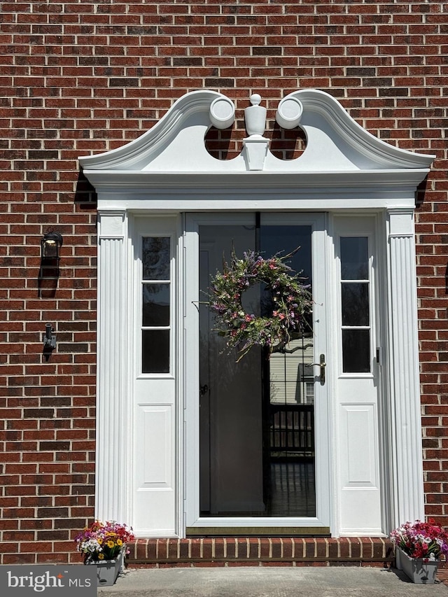 property entrance with brick siding
