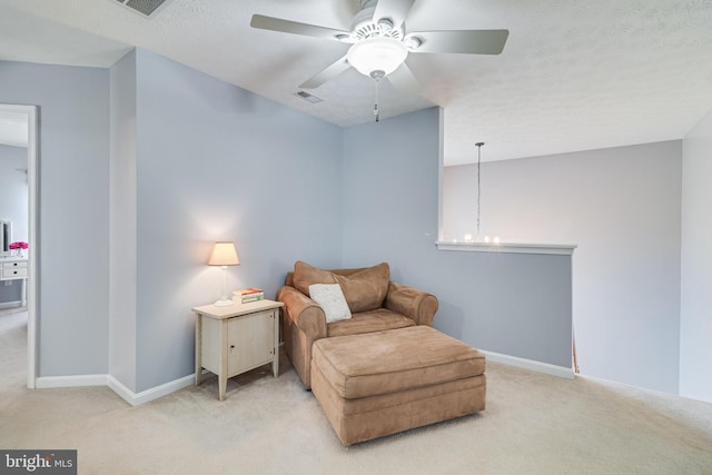 sitting room featuring visible vents, ceiling fan, carpet flooring, and baseboards