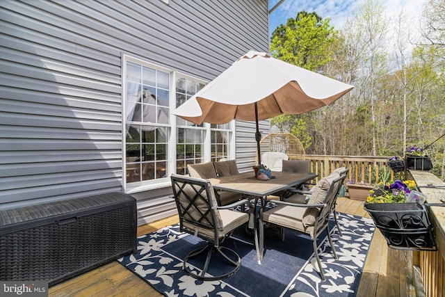 deck with outdoor dining area