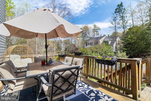 wooden terrace featuring outdoor dining space