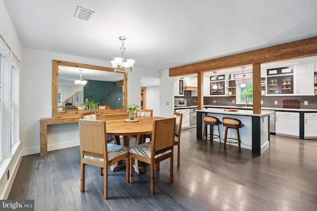 6750 Stonehurst Ct, Warrenton, VA 20187 - dining area with a chandelier, dark wood-type flooring, stairs, and baseboards