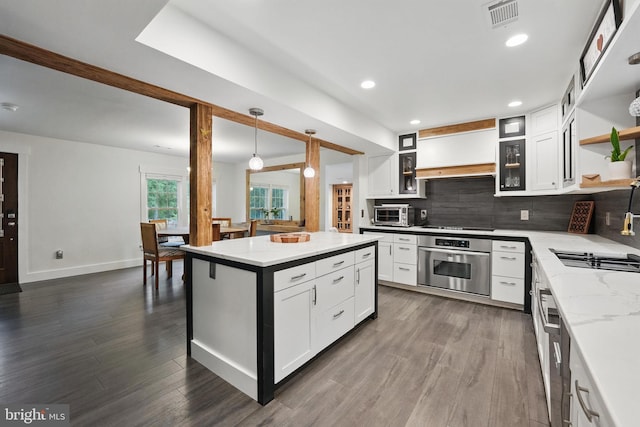 6750 Stonehurst Ct, Warrenton, VA 20187 - kitchen featuring oven, open shelves, decorative backsplash, white cabinets, and light stone countertops