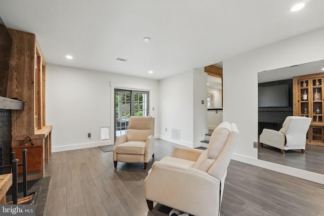 6750 Stonehurst Ct, Warrenton, VA 20187 - living area featuring wood finished floors, recessed lighting, baseboards, and a fireplace