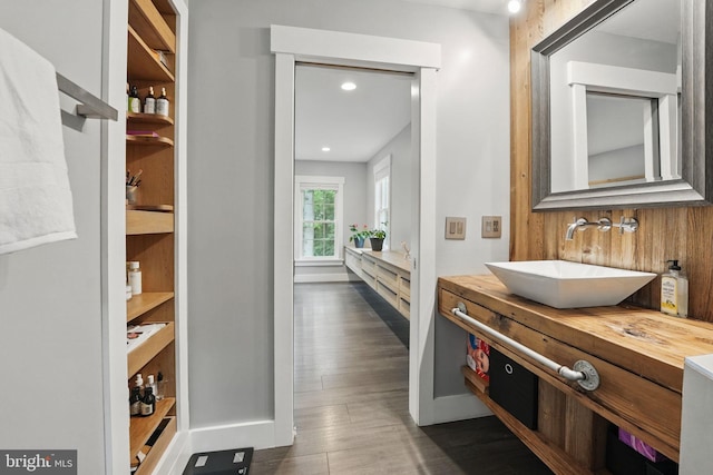 6750 Stonehurst Ct, Warrenton, VA 20187 - hallway with a sink, dark wood-type flooring, recessed lighting, and baseboards