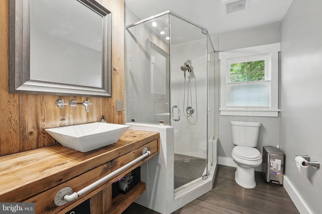 6750 Stonehurst Ct, Warrenton, VA 20187 - bathroom with toilet, vanity, a stall shower, wood finished floors, and baseboards