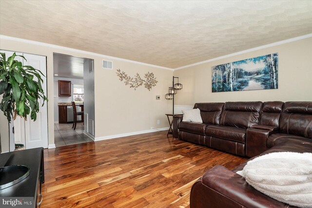421 Burbank Ct, Baltimore, MD 21227 - living area featuring wood finished floors, crown molding, baseboards, and a textured ceiling