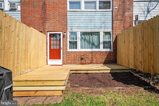 421 Burbank Ct, Baltimore, MD 21227 - doorway to property with brick siding and a wooden deck