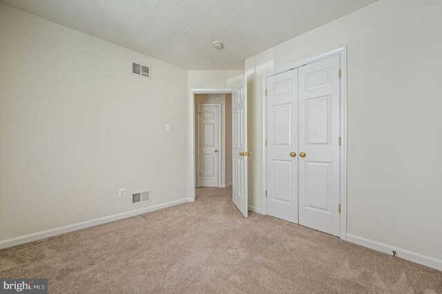 720 Birch Tree Ln, Smyrna, DE 19977 - unfurnished bedroom featuring light carpet, a closet, and baseboards
