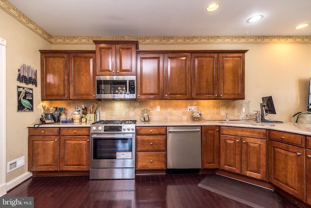 14 Komen Ct, Sellersville, PA 18960 - kitchen with tasteful backsplash, dark wood-style flooring, and appliances with stainless steel finishes