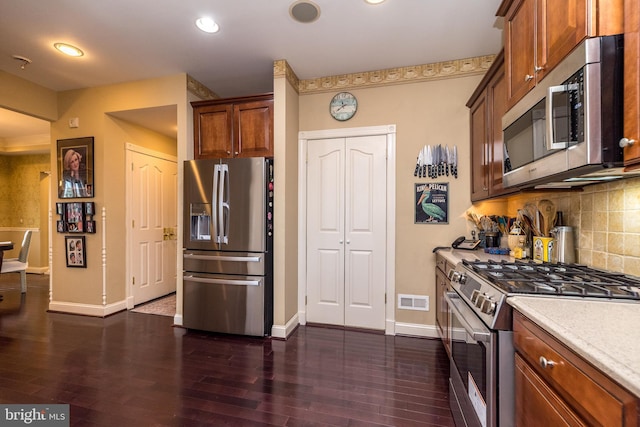 14 Komen Ct, Sellersville, PA 18960 - kitchen with visible vents, dark wood-style flooring, light countertops, appliances with stainless steel finishes, and decorative backsplash