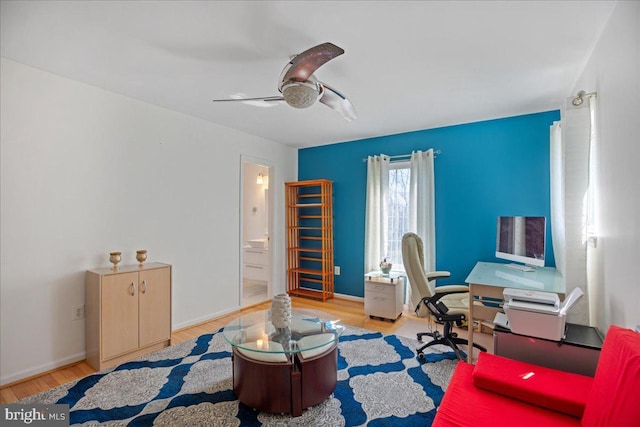 home office featuring baseboards, ceiling fan, and wood finished floors