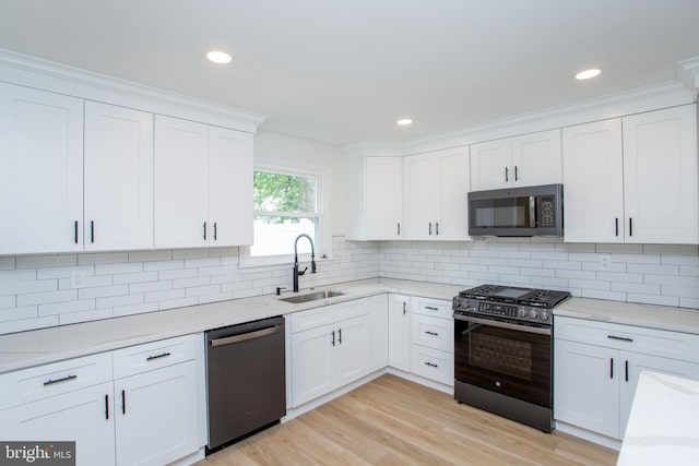 1102 Dolores Ln, Croydon, PA 19021 - kitchen featuring dishwasher, gas range, a sink, white cabinets, and backsplash