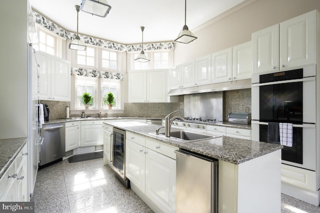 2838 Mcgill Ter NW, Washington, DC 20008 - kitchen with multiple ovens, beverage cooler, dishwasher, a kitchen island with sink, and white cabinetry