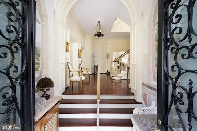 2838 Mcgill Ter NW, Washington, DC 20008 - entryway with stairs, arched walkways, crown molding, and a chandelier