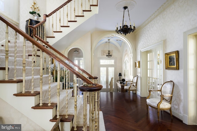 2838 Mcgill Ter NW, Washington, DC 20008 - entrance foyer with french doors, a chandelier, a high ceiling, stairway, and arched walkways