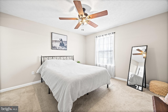 carpeted bedroom with baseboards, a textured ceiling, and ceiling fan