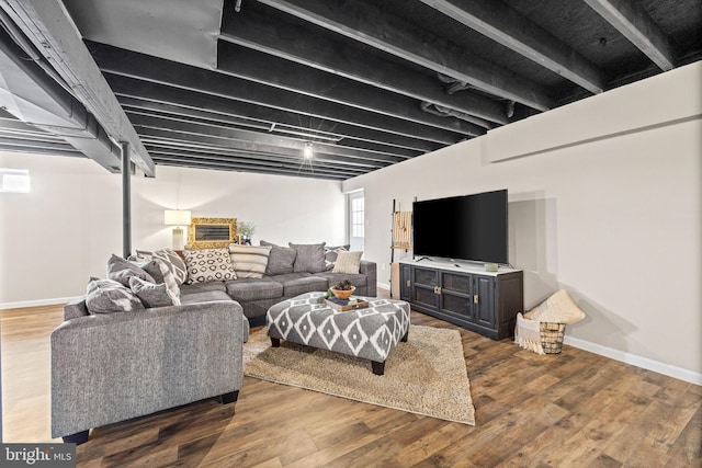 living area with baseboards and wood finished floors