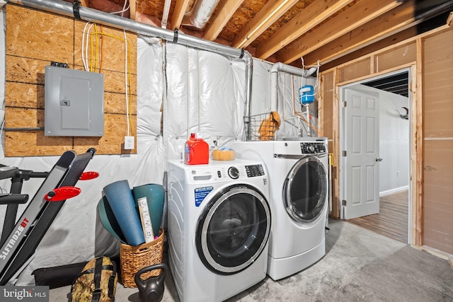 laundry area with electric panel, independent washer and dryer, and laundry area