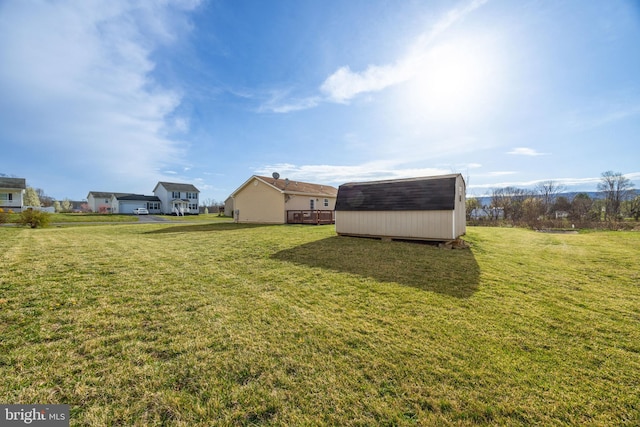 view of yard featuring an outbuilding and a shed