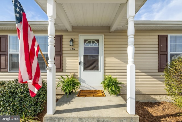 view of exterior entry with a porch