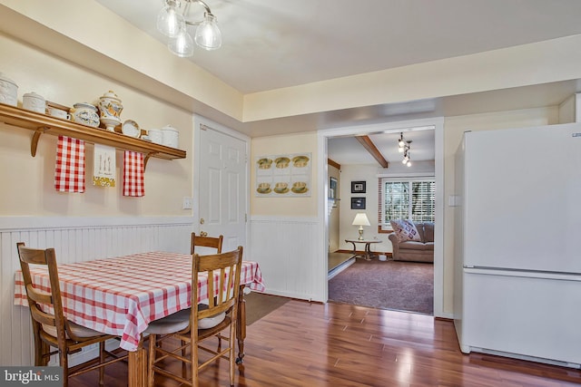 dining area with wainscoting and wood finished floors