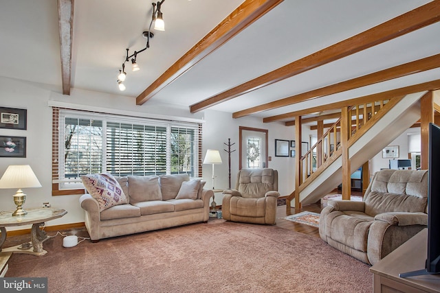 living room with baseboards, carpet, beam ceiling, and stairs