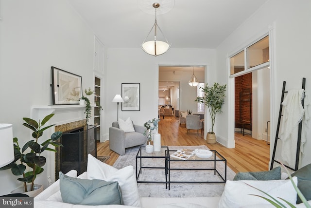 living area with wood finished floors and a fireplace