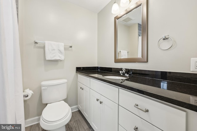 1905 S Glebe Rd, Arlington, VA 22204 - full bathroom with toilet, baseboards, wood finished floors, and vanity