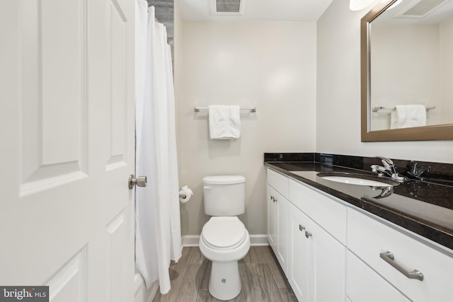 1905 S Glebe Rd, Arlington, VA 22204 - bathroom featuring visible vents, wood finished floors, vanity, baseboards, and toilet