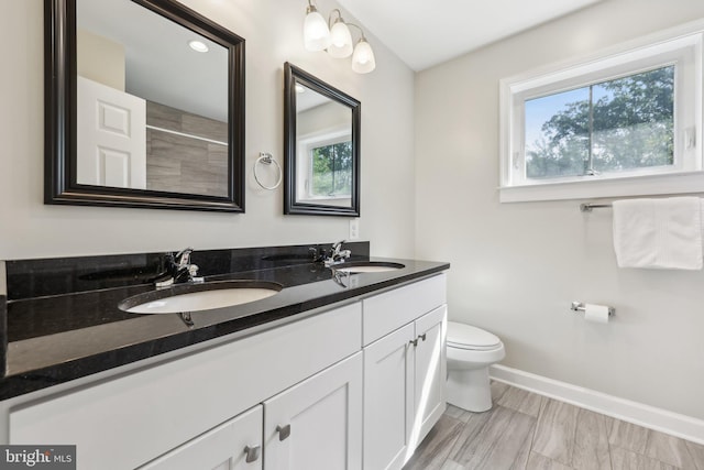 1905 S Glebe Rd, Arlington, VA 22204 - full bathroom featuring a sink, baseboards, toilet, and double vanity