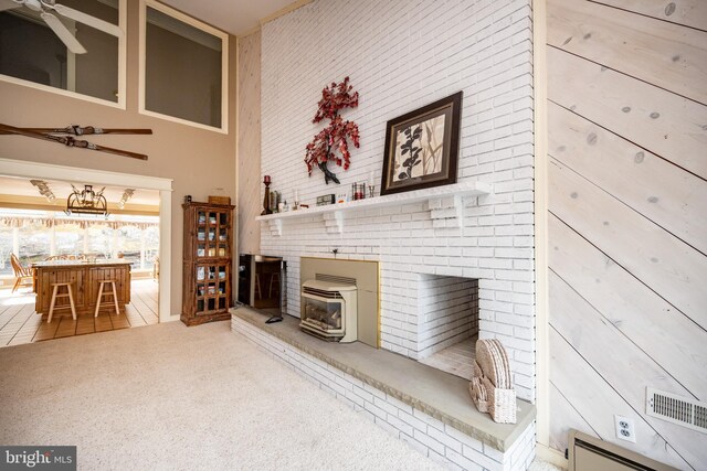 1909 Marsh Hill Rd, Mc Henry, MD 21541 - tiled living room featuring carpet floors, a high ceiling, a wood stove, a baseboard radiator, and ceiling fan