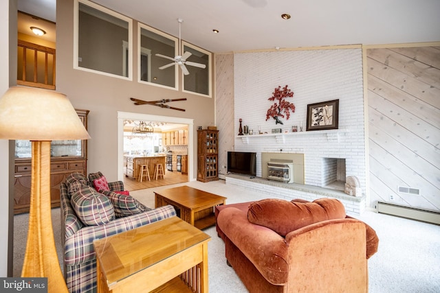 1909 Marsh Hill Rd, Mc Henry, MD 21541 - carpeted living room with a brick fireplace, wood walls, a towering ceiling, a baseboard radiator, and a ceiling fan