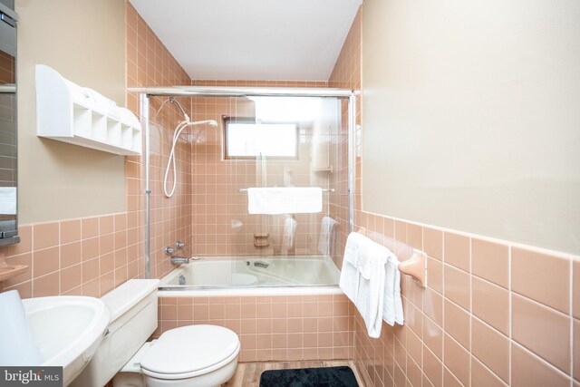 1909 Marsh Hill Rd, Mc Henry, MD 21541 - full bathroom with tiled shower / bath combo, toilet, tile walls, and wainscoting