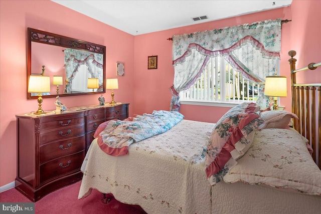 carpeted bedroom with visible vents and baseboards
