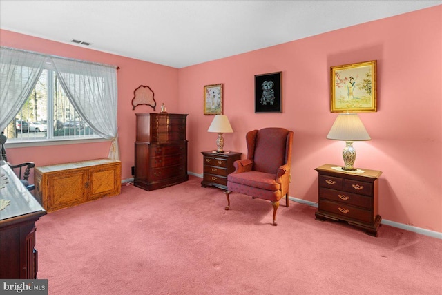 sitting room with visible vents, baseboards, and carpet
