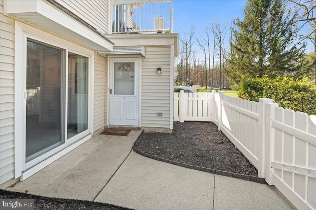 doorway to property featuring fence