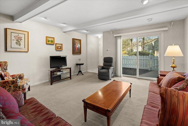 living area with beamed ceiling, baseboards, and carpet