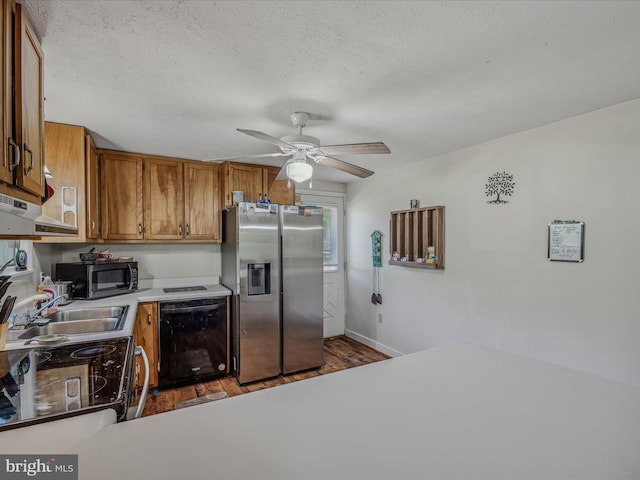 kitchen featuring light countertops, ceiling fan, brown cabinets, stainless steel appliances, and dark wood-style floors