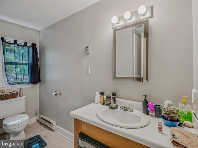 bathroom featuring vanity, baseboards, toilet, and baseboard heating