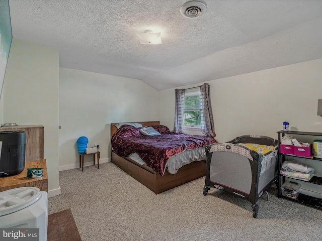 carpeted bedroom featuring baseboards, a textured ceiling, visible vents, and vaulted ceiling