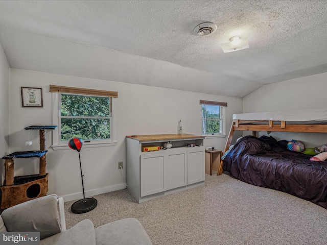 bedroom featuring vaulted ceiling, a textured ceiling, baseboards, light colored carpet, and visible vents