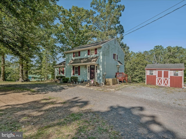 view of front facade with an outdoor structure and a storage shed