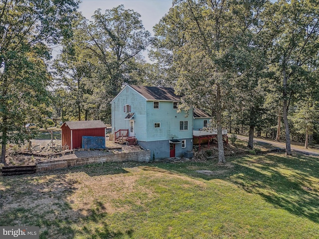exterior space featuring a yard, an outbuilding, and a storage shed