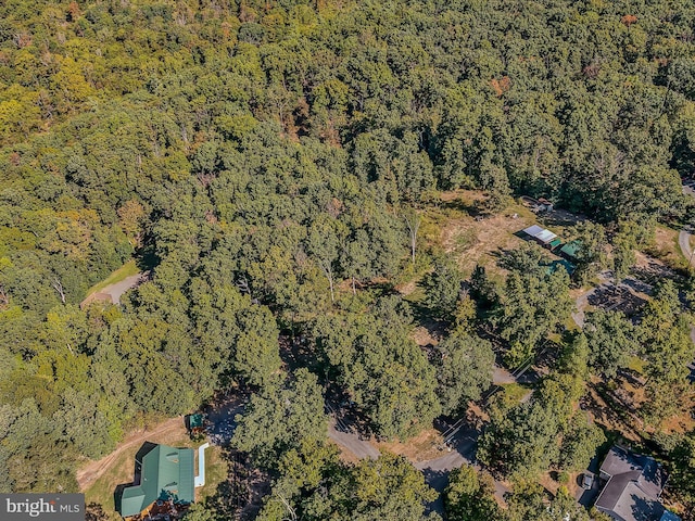 drone / aerial view featuring a forest view