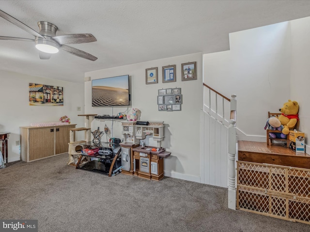 interior space featuring carpet flooring, a textured ceiling, stairway, and a ceiling fan